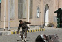 A police officer walks past debris outside the building of Sanaa Airport, one day after Israeli airstrikes hit the airport, in Sanaa, Yemen, December 27, 2024.