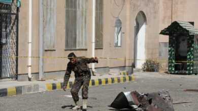 A police officer walks past debris outside the building of Sanaa Airport, one day after Israeli airstrikes hit the airport, in Sanaa, Yemen, December 27, 2024.