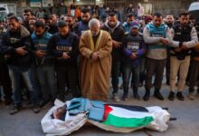 Journalists , Mourners in Nuseirat on December 16, 2024 pray in front of the body of Al Jazeera journalist Ahmad Baker Al-Louh, who was killed along with Civil Defence members in an Israeli strike the day before.