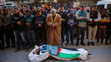 Journalists , Mourners in Nuseirat on December 16, 2024 pray in front of the body of Al Jazeera journalist Ahmad Baker Al-Louh, who was killed along with Civil Defence members in an Israeli strike the day before.