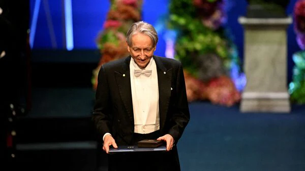 Nobel Laureate in Physics Geoffrey E. Hinton holds his award at the Nobel Prize ceremony in the Konserthuset in Stockholm, Sweden, on December 10, 2024.